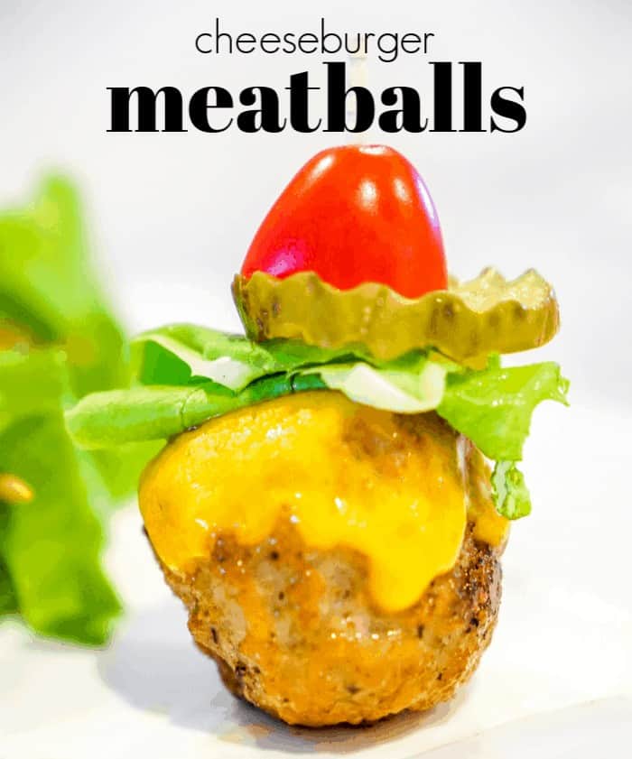 cheeseburger meatballs with tomato, pickles and lettuce on a skewer. These cheeseburger meatballs are our favorite cocktail meatball recipes. Serve these mini burgers or any cocktail meatball at your Superbowl party.