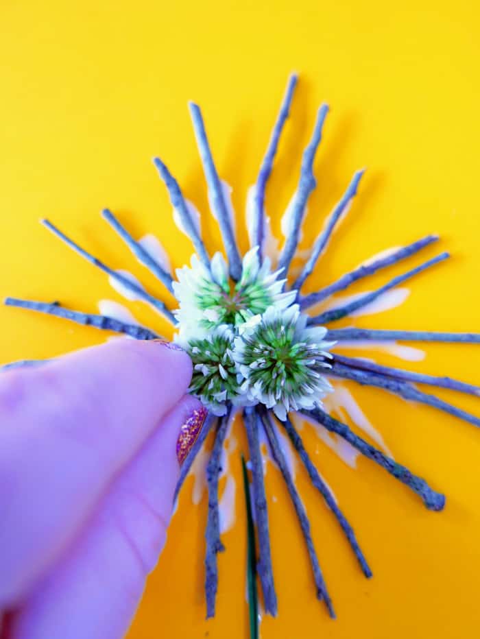 glue flowers to middle of twigs