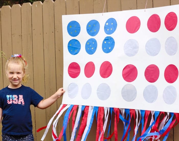 little girl hanging 4th of July pinata