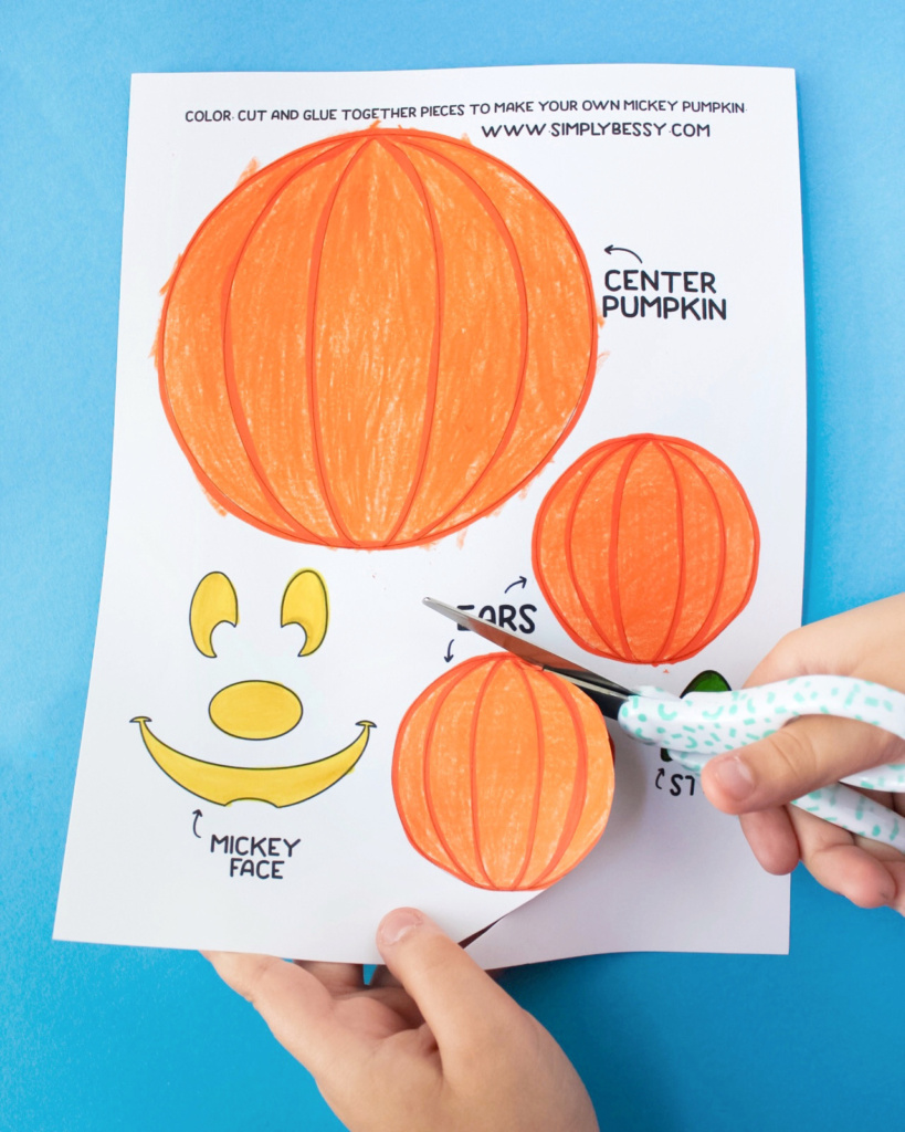 child cutting mickey pumpkin craft