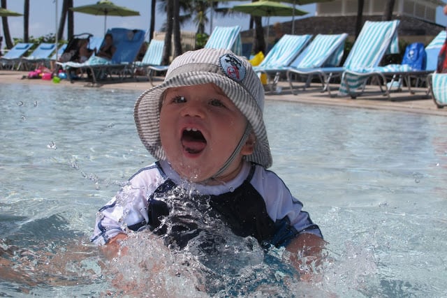 baby splashing water at pool in Atlantis Bahamas