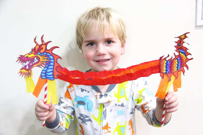 child holding dragon puppet