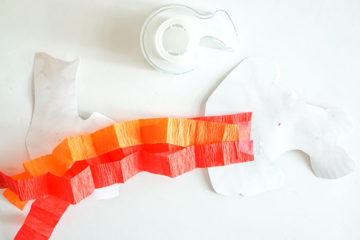 tape the ends of the crepe paper to the backside of the dragon puppet