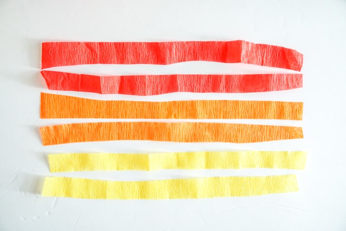 red, orange and yellow crepe paper cut in half