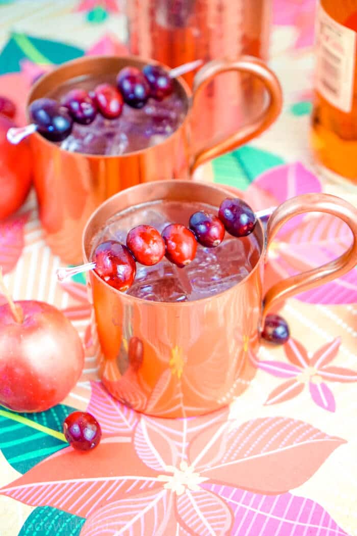 Cranberry Apple Mule Cocktail. Holiday Party Cocktail Ideas. Christmas Cocktail Recipes. Moscow Mules made with Rum. Cranberry Apple Mule Made with Rum. www.madewithhappy.com