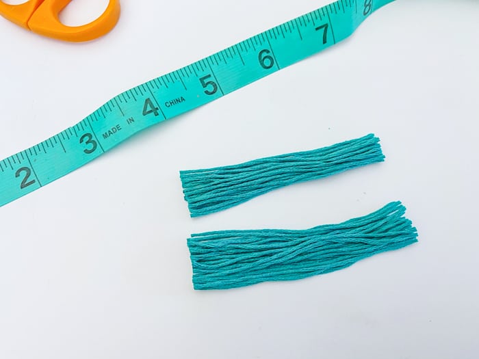 Cut pieces of embroidery floss same length