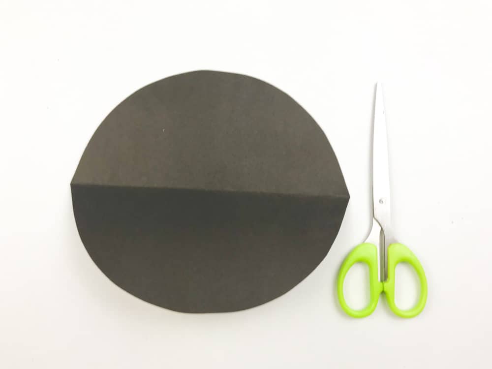 fold black paper in half and cut an arch
