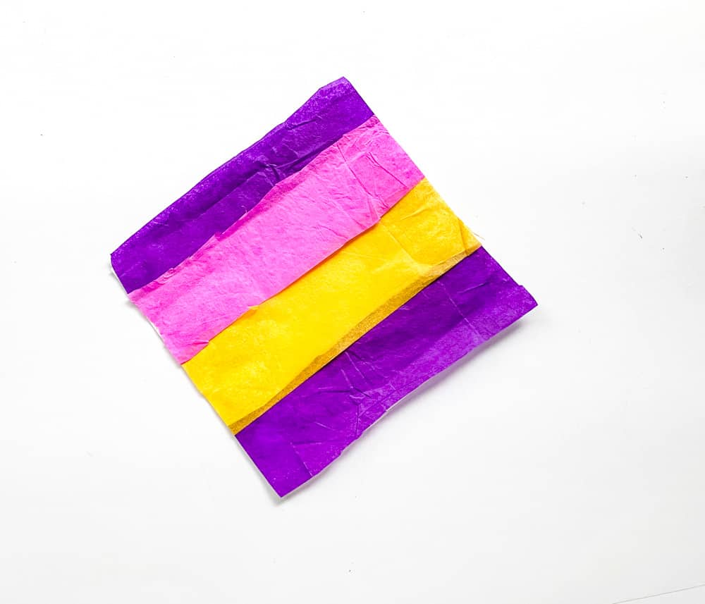 Fill up the white tissue paper using the pieces of colourful tissue papers.