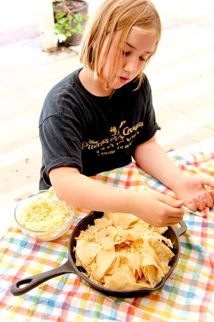 Simple and delicious ingredients to make these Campfire Nachos for your next camping trip or backyard BBQ. Camping Recipes. Simple campfire recipe ideas.