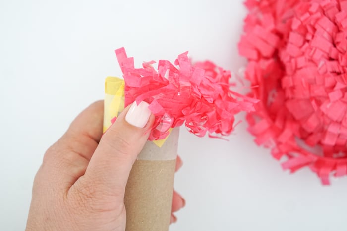 Add fringe to toilet paper roll