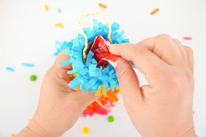 Putting Candy in the top of the pinata