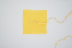 String taped on tissue paper