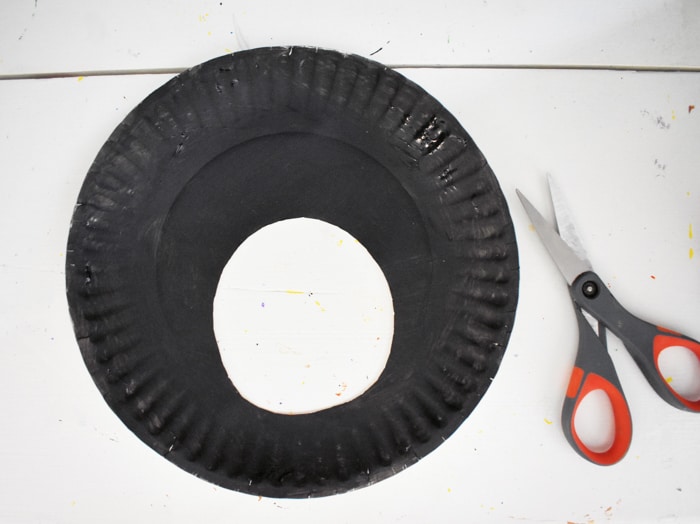 Cut circle out of black paper plate