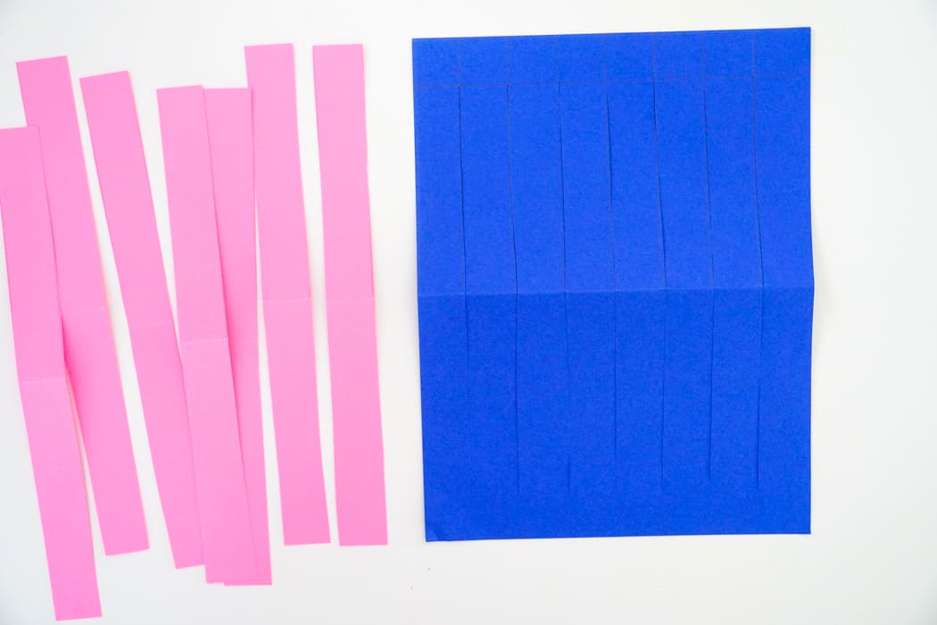 strips of paper next to cut base paper