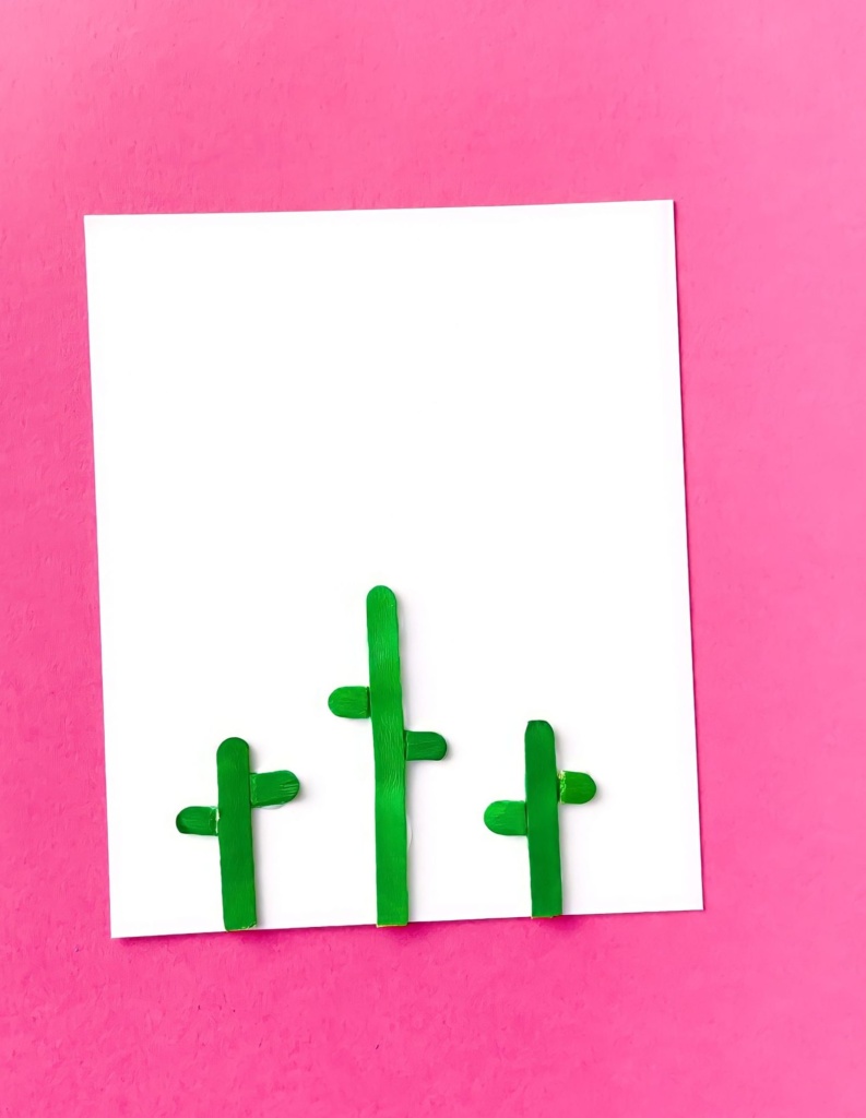 green craft sticks on white paper button flowers craft