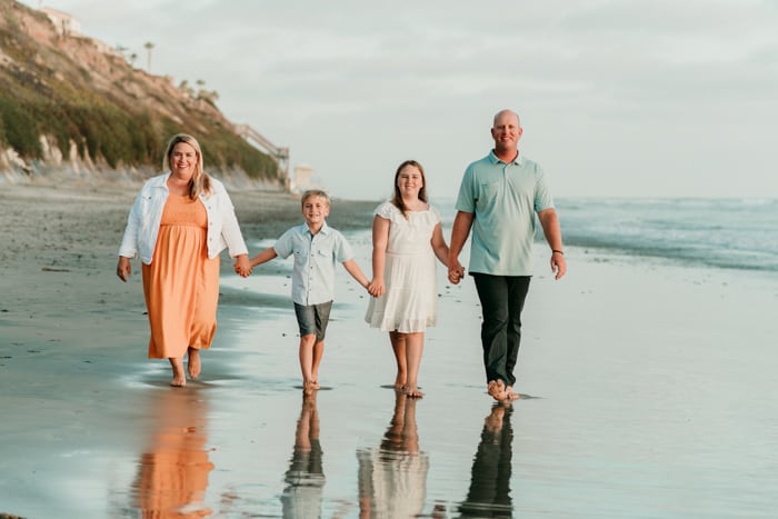 family walking along beach