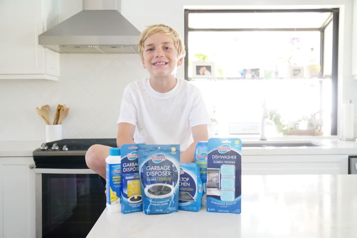 Kid with cleaning supplies
