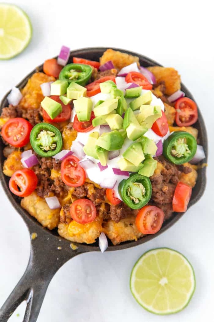 Loaded Tater Tot Nachos with all the fixings. These loaded tater tot nachos recipe is the perfect game day appetizer. We have what is soon to be your favorite totchos recipe loaded with all the fixings.