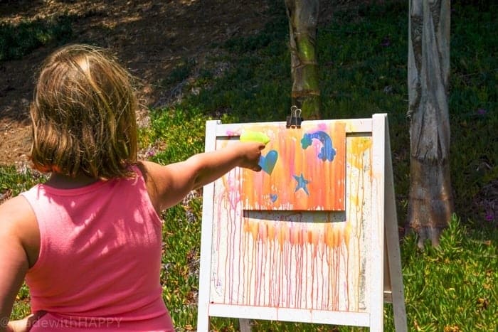 Water gun painting. Looking for Summer activities for the kids? The kids LOVE water gun painting throughout the Summer.