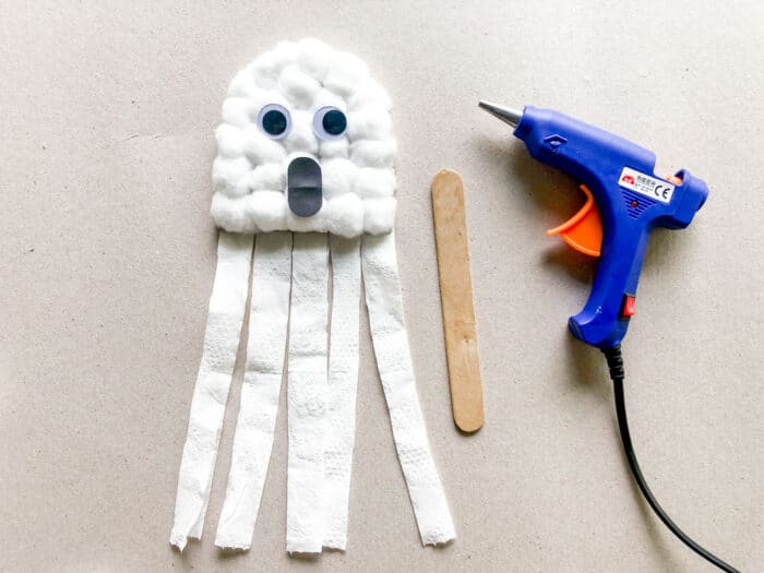 add popsicle stick to back of ghost