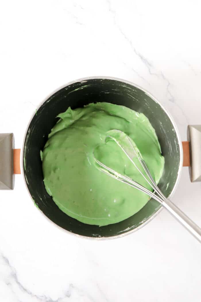adding green coloring to melted marshmallow