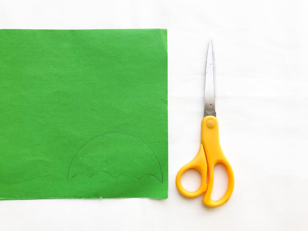 green paper and scissors to make apple craft