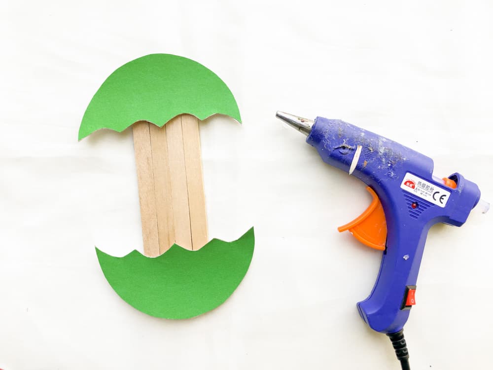 glue the two apple slices to the bottom of the popsicle sticks