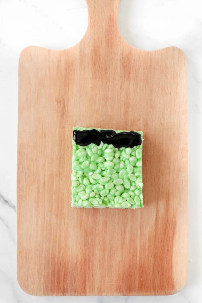 cut green rice krispie and add black icing as Frankenstein's hair