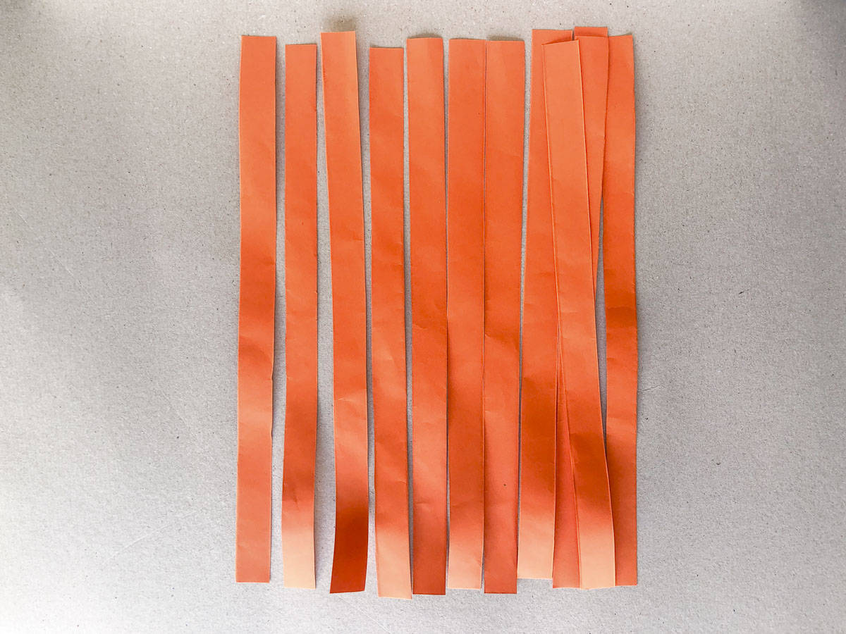 cut orange paper strips for 3D pumpkin