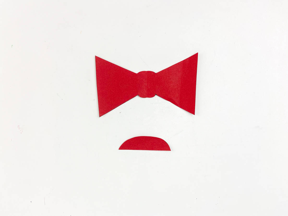 cut out vampire bow tie and mouth from red paper