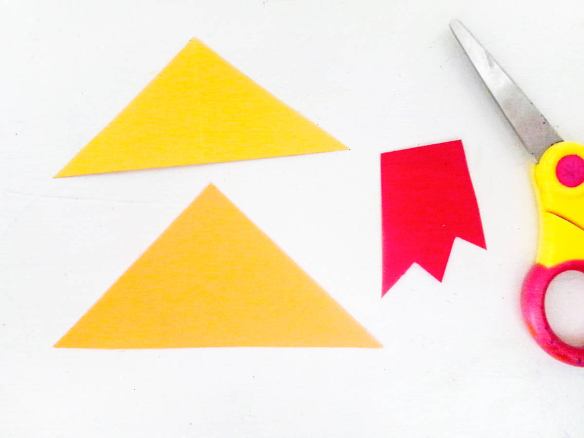 cut triangles out of construction paper for love rocket
