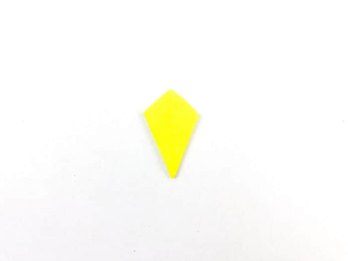 cut yellow reminant paper into a diamond kite shape