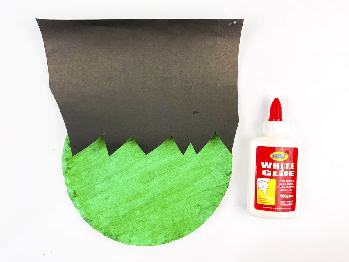 glue black paper to green paper plate
