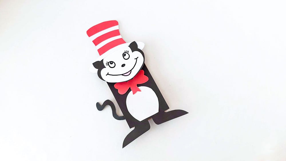 glue bow tie and tail to paper bag puppet cat in the hat