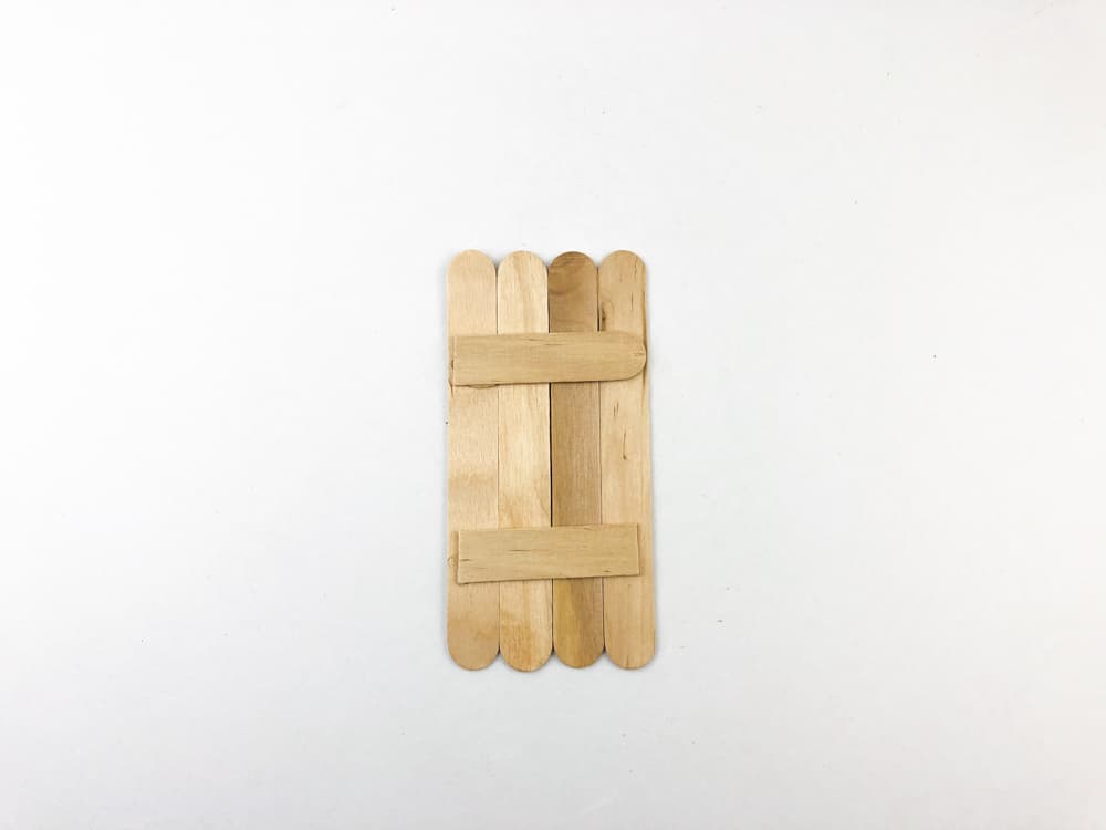 glue four popsicle sticks on the two half pieces