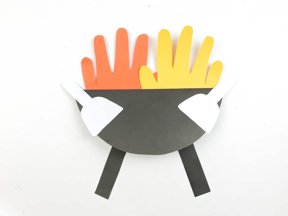 Glue Hands and black strips to back of folded grill spatulas to front
