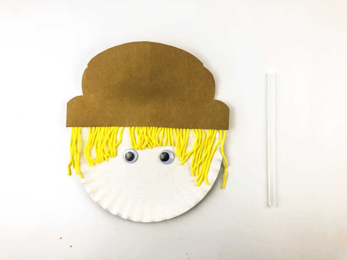 glue on googly eyes to paper plate scarecrow
