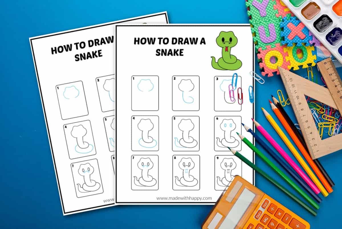 A step-by-step drawing guide on how to draw a snake, with two sheets illustrating the process. The sheets are set on a blue surface surrounded by colorful pencils, paper clips, a ruler, and a calculator.