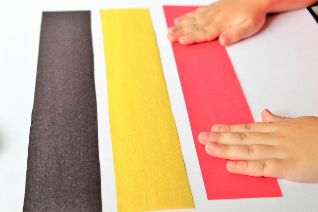 child hands on pieces of construction paper for Disney countdown activity