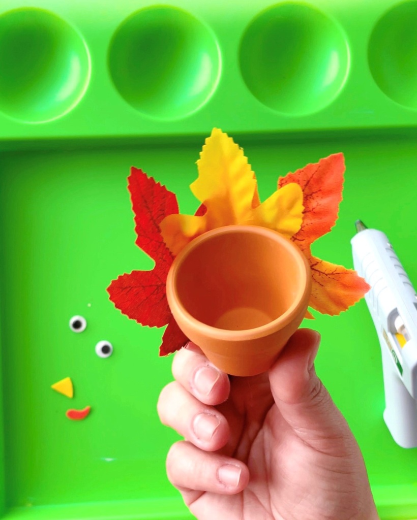 mini planter turkey craft step 1 - thanksgiving party supplies make for a great addition to any thanksgiving events