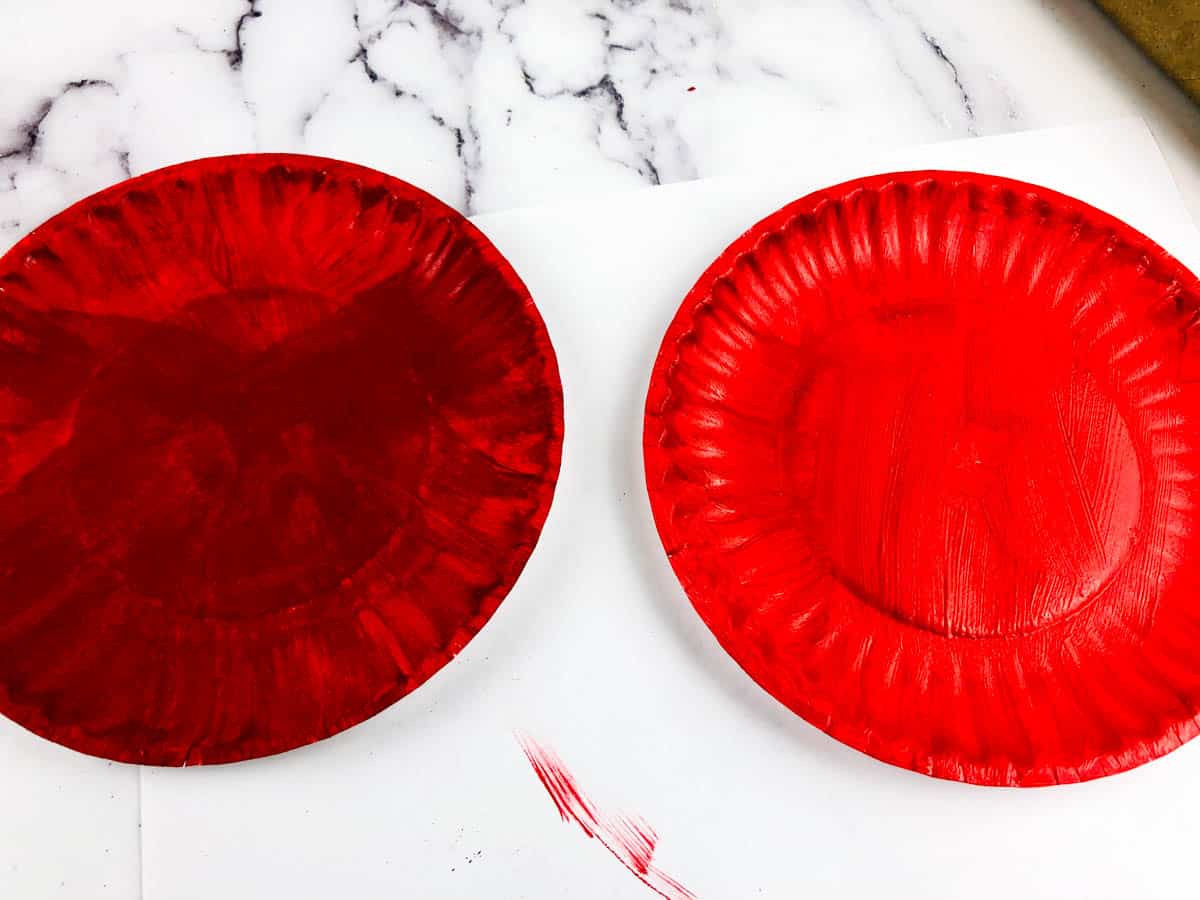 paint two paper plates red for bird feeder craft