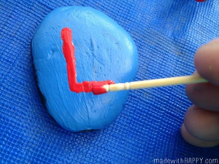 painting letters on rocks