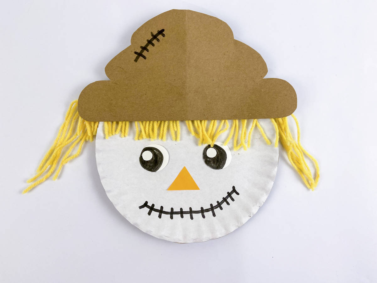 scarecrow paper plate craft with hand drawn eyes