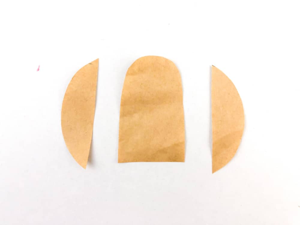 three shapes cut out of light brown paper
