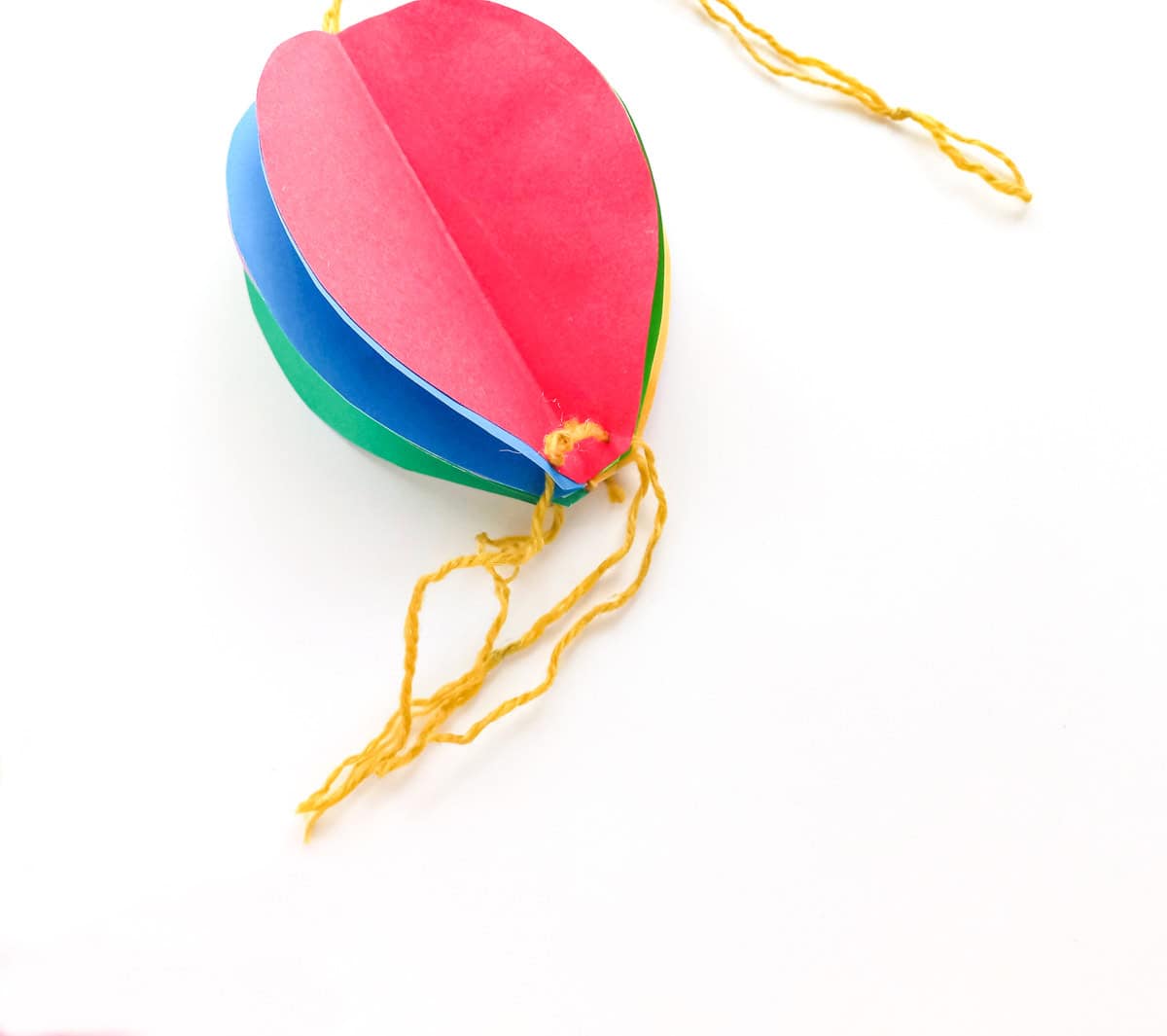 tie strings to holes at bottom of balloon