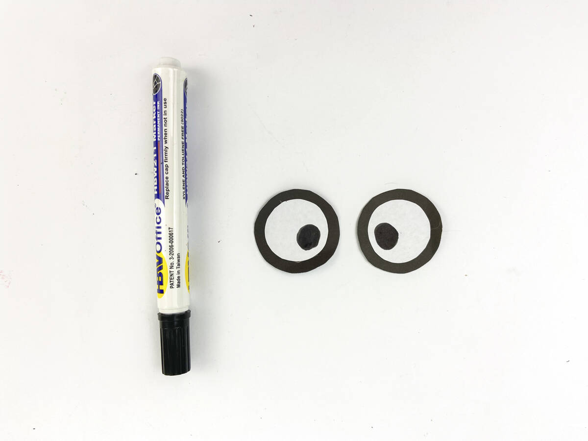 use a marker to draw on vampire eyes on white circles