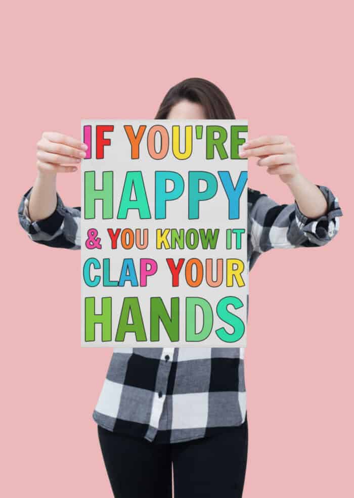 woman holding a poster of happy