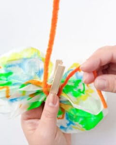 Wrap pipe cleaner under clothes pin